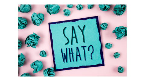 Crumpled up paper surrounding a sign that says, say what?