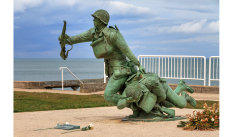 A soldier pulling another soldier to safety