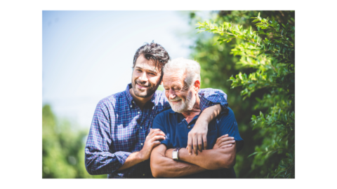 Gentleman with his arm around an older gentleman
