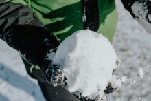 Person holding a snowball in their hand