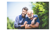 Gentleman with his arm around an older gentleman